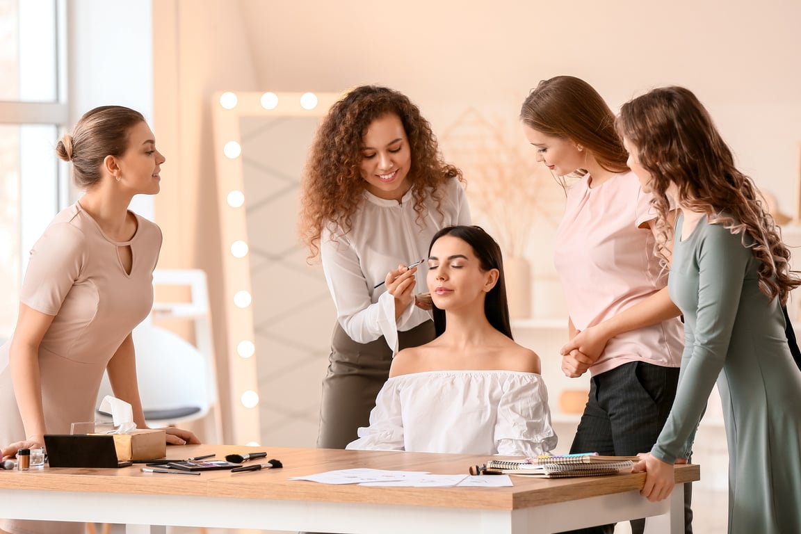 Young Woman Teaching Students in Makeup School